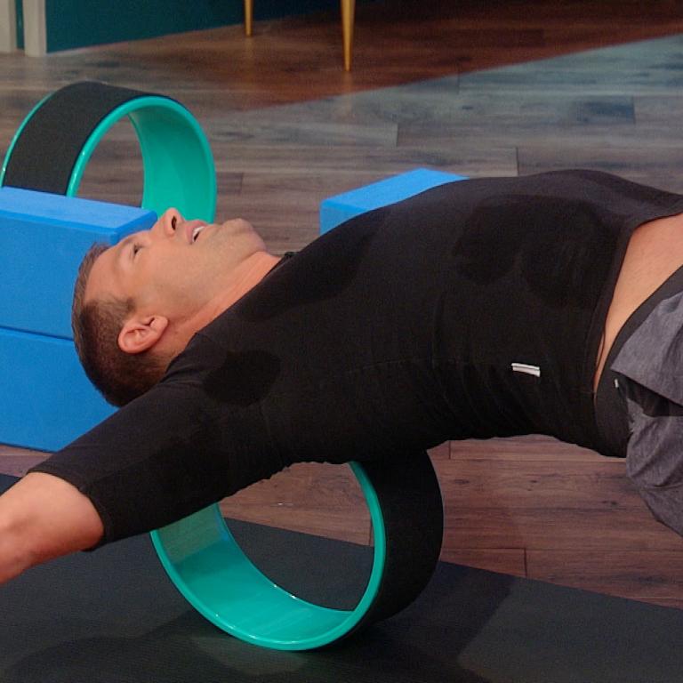 Travis Stork on a yoga wheel