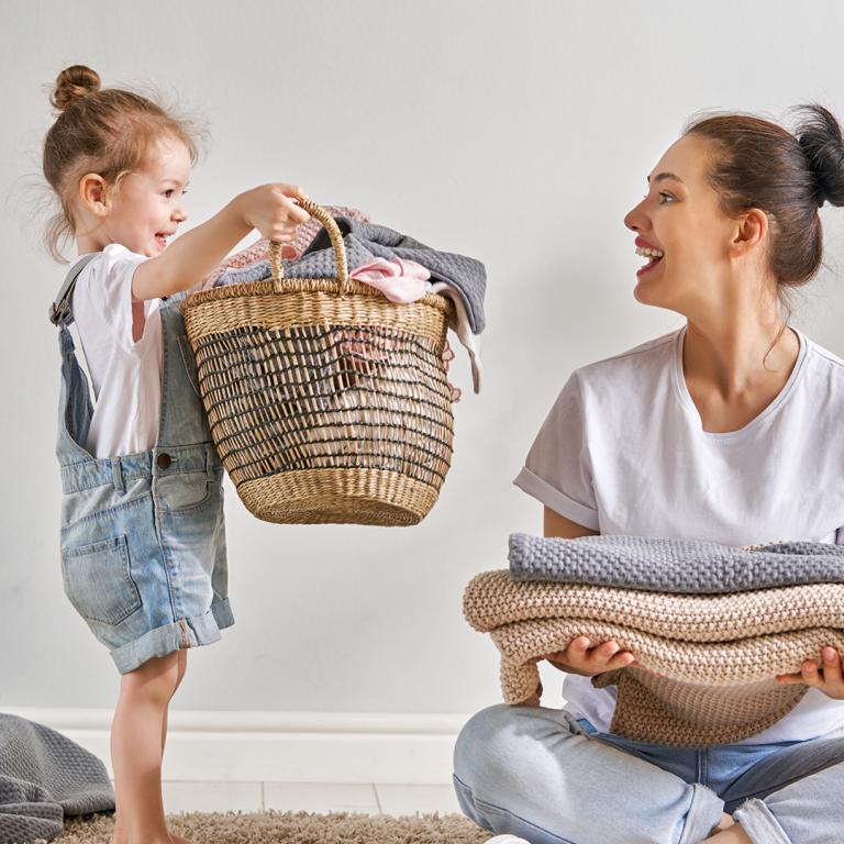 Young Girl With Mom Holding Laundry Basket