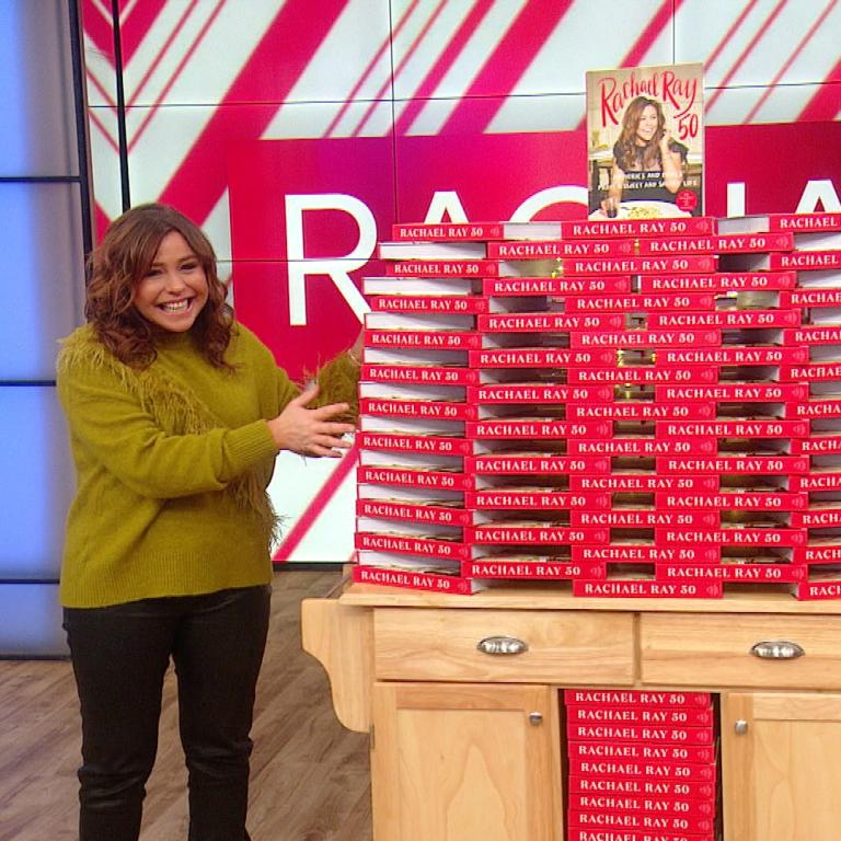 Rachael Ray with copies of her cookbook