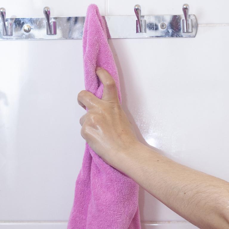 woman's hand reaching for a towel