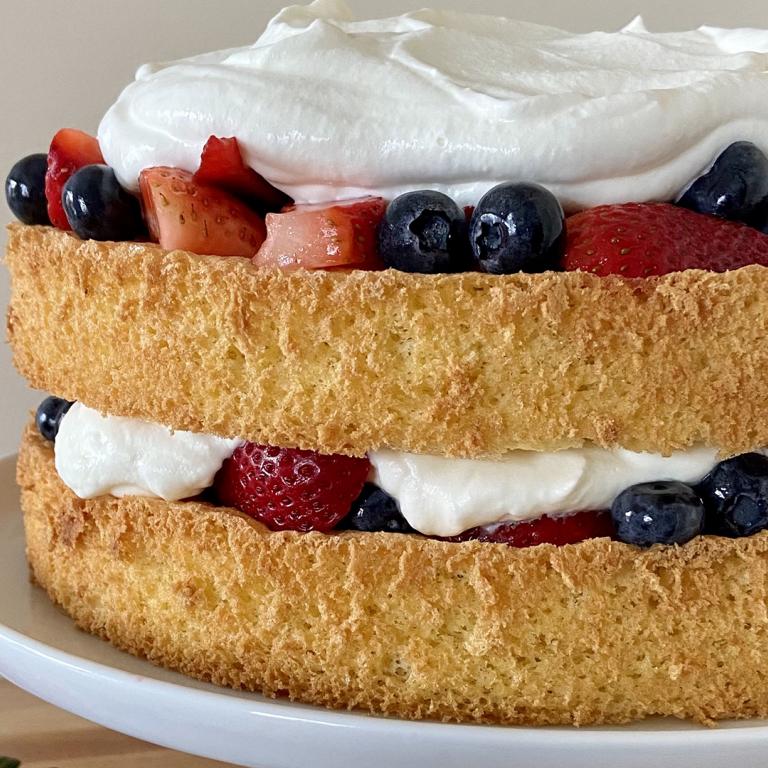 sponge cake with berries and whipped cream