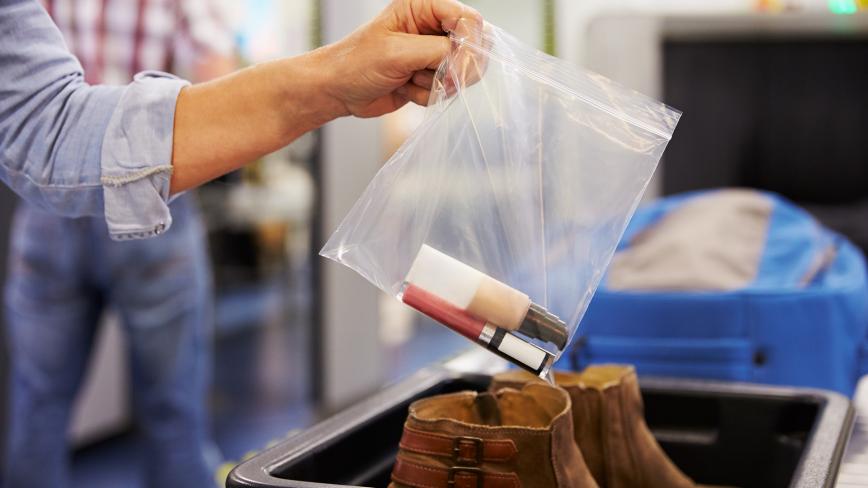 woman's hand holding plastic bag with liquids at airport security