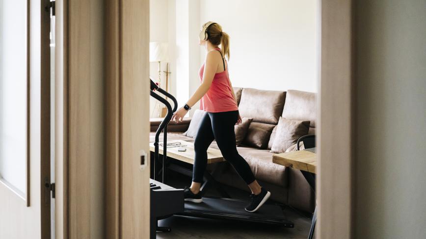 Woman Working Out At Home On Treadmill