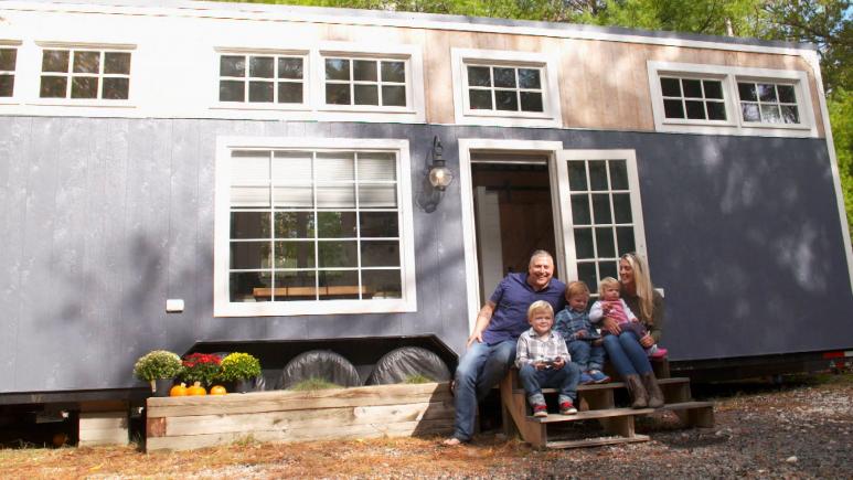 family of 5 in front of tiny house