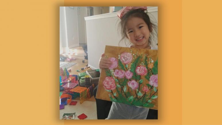 Juliette holding her painting